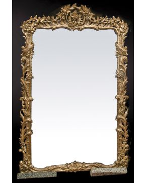 614-Gran espejo en madera tallada y dorada con profusa decoración vegetal e importante copete de guinalda. s. XIX.