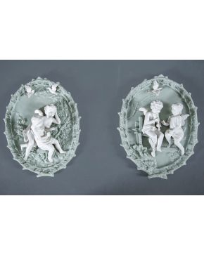 751-Pareja de tondos en biscuit centoeuropea de fondo verde con dos figuras alegóricas en bulto redondo en blanco. s. XIX.
