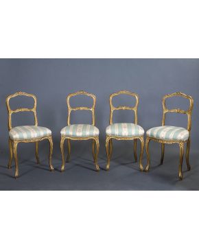 871-Juego de cuatro sillas Napoleón III. siglo XIX. en madera de haya tallada y dorada con decoración vegetal en relieve. Tapicería a rayas con motivos fl