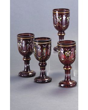 1186-Juego de cuatro copas en cristal austriaco moldeado y tallado a rueda color rojo rubí con decoración floral pintada. Filos y detalles en dorado. C.190