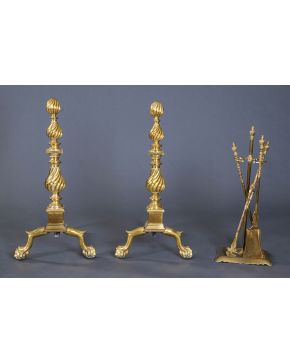 1069-Lote formado por pareja de morillos con decoración helicoidal y patas de garra sobre bola. y juego de atizadores en bronce dorado.