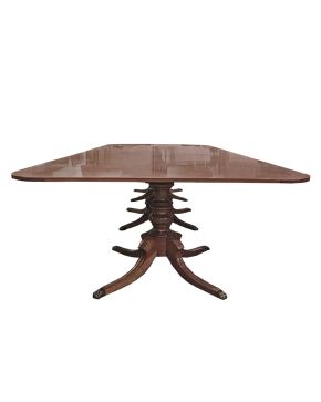 821-Mesa de reuniones o comedor rectangular en madera tallada. Sobre tres pies abalaustrados apoyados en cuatro patas rematadas en dedales con forma de ga