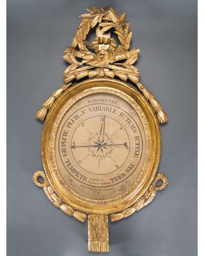 664-Barómetro francés con marco oval en madera tallada y dorada Luis XVI con copete de antorchas. aves. motivos vegetales y lazos.