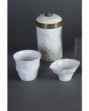 508-Lote de 3 piezas en porcelana europea Blanc de Chine. ff. s. XIX. Cuenco. vaso y recipiente con tapa y montura metálica.
