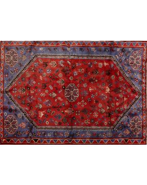 843-Alfombra persa Shiraz en lana. Decoración de motivos vegetales y animales estilizados sobre campo granate. Desgastes.