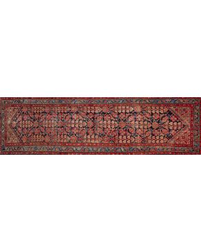 1431-Lote de dos alfombras: una BALUCHI y otra MALAYER. con tramas de algodón y lana. Decoración geométrica sobre campos granate y azul oscuro. Algún desga