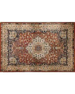 1260-Lote de dos alfombras persas en lana con decoración vegetal sobre campo azul marino y cenefas en ocres y marrones. 