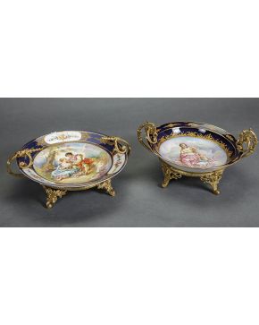585-Lote de dos platos decorativos en porcelana de Sévres en azul cobalto con detalles en dorado. Monturas en bronce dorado. Uno de ellos con piquete. 