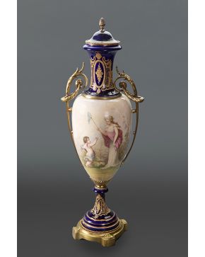 590-Jarrón con tapa en procelana de Sévres azul cobalto con monturas y asas con guirnaldas en bronce dorado. Escena de dama con Cupido en el cuerpo. Detal