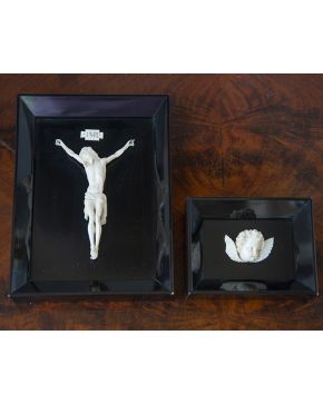 1183-Lote en de dos imágenes religiosas: Cristo de tres clavos sobre fondo negro y cabeza de querubín de marfil siguiendo modelos italianos. c. 1900. Enmar
