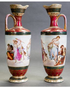 1157-Pareja de elegantes jarras en porcelana de Viena. s. XIX. Escenas clásicas esmaltadas y grecas y detalles en dorado. 
