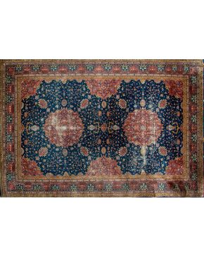 452-Bella alfombra persa en lana con decoración vegetal y de flores sobre campo azul oscuro y reservas en granate. 