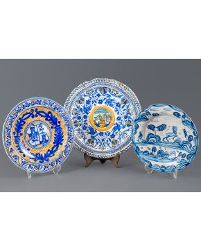 864-Lote de tres platos en cerámica española. uno de ellos blasonado. XX. Pelos.