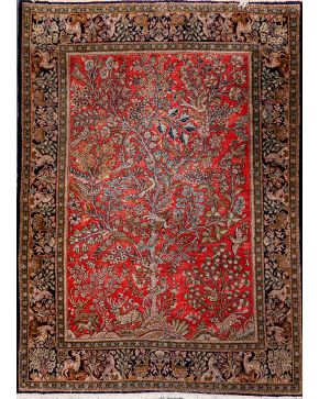 522-Alfombra persa en lana con representación del árbol de la vida sobre campo granate.