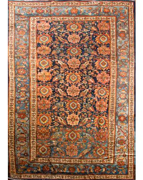 913-Importante alfombra persa en lana Malayer con decoración de flores y elementos vegetales sobre campo azul. Medidas: 350x250 cm aprox.