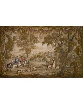 786-Tapiz Aubusson  en lana, época Luis XVI. Francia, c.1780. Representa una escena de cacería en paisaje boscoso con arquitecturas de fondo que queda enmmarcada a modo de cenefa con elegantes drap