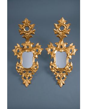 806-Pareja de cornucopias con espejo en madera tallada y dorada con decoración de flores y elementos vegetales s. XIX Medidas: 102x50cm.