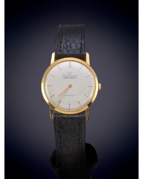 1087-UNIVERSAL GENEVE. AÑOS 70. CAJA EN ORO AMARILLO DE 18K. MOVIMIENTO AUTOMÁTICO. ESFERA GRIS CON NUMERACIÓN A TRAZOS APLIC