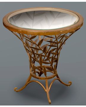 357-Mesa gueridón circular en hierro con base en forma de hojas caladas y tapa de cristal. Sobre cuatro patitas.  Me