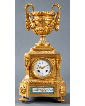 981-Reloj de sobremesa francés, s. XIX, en bronce dorado con aplicaciones de porcela