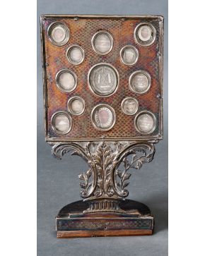 991-Relicario en plata con decoración de acanto y tornapuntas en fuste y cuerpo superior con trece reliquias. Presenta faltas. Altura: 40 cm. 