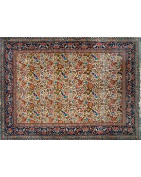 422-Gran alfombra persa cuajada de motivos florales sobre campo crema con cenefa en azul marino decorada con jarrones de