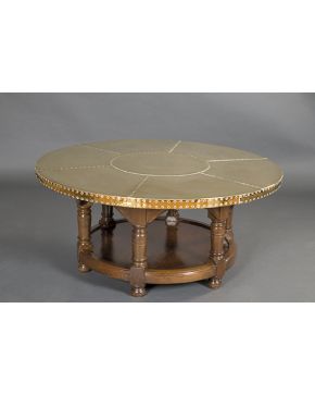 435-Mesa de centro circular en madera tallada y láminas de latón dorado tachuelado.