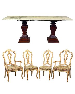 439-Lote formado por cuatro sillas y dos butacas en madera lacada y dorada; y una mesa con tapa de mármol sobre pedestales en madera tallada y patinada.